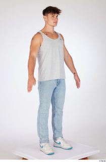 Darren a-poses blue jeans casual dressed grey tank top standing…